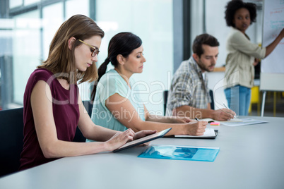 Business executive using digital tablet in meeting