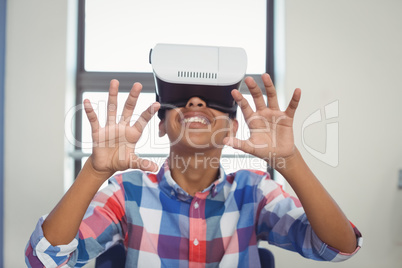 Schoolboy using virtual reality headset in classroom