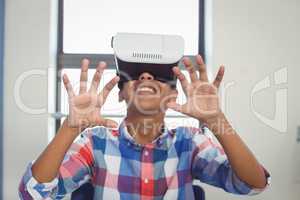 Schoolboy using virtual reality headset in classroom