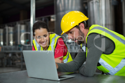Factory workers using digital tablet