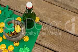 St. Patricks Day shamrock, beer bottle and pot filled with chocolate gold coins
