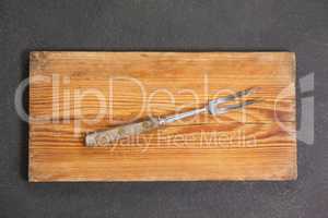 Fork on wooden board