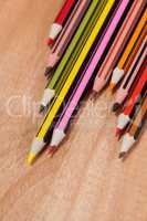 Close-up of colored pencils arranged in a wave pattern