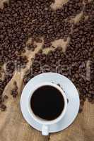 Black coffee and coffee beans on sack