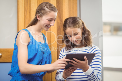 Students using digital tablet in classroom