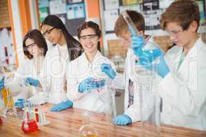 Attentive school kids doing a chemical experiment in laboratory
