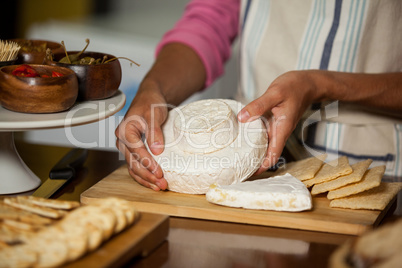 Mid-section of staff working at counter