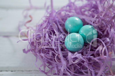 Turquoise Easter eggs in the violet nest