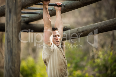 Soldier climbing monkey bars