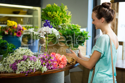 Woman holding pot plant