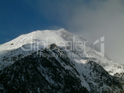 Snowy mountain peaks in a beautiful winter day