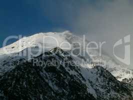 Snowy mountain peaks in a beautiful winter day