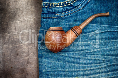 smoking wooden pipe on blue dzhinskah worn