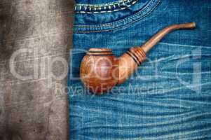 smoking wooden pipe on blue dzhinskah worn