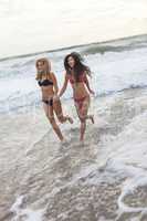 Girls Young Women in Bikinis Running on Beach