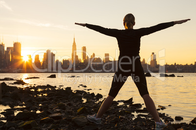 Woman Exercising at Sunrise New York City Skyline