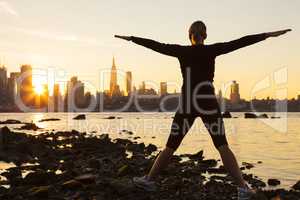 Woman Exercising at Sunrise New York City Skyline