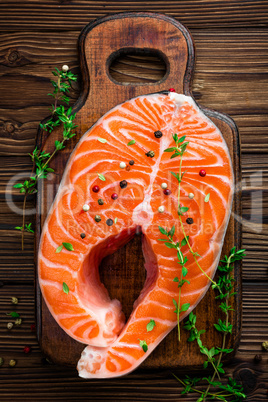 Salmon fish steak on wooden rustic background top view