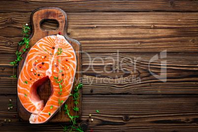 Salmon fish steak on black background copy space top view