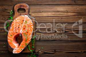 Salmon fish steak on black background copy space top view