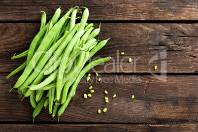 Fresh green beans on dark wooden rustic background top view copy space flat lay