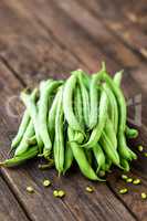 Fresh green beans on dark wooden rustic background