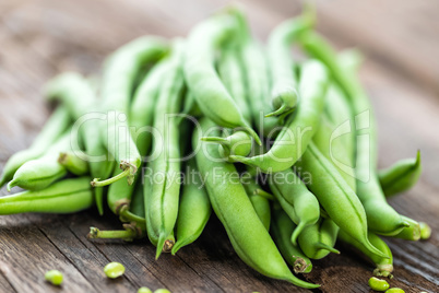 Fresh green beans on dark wooden rustic background