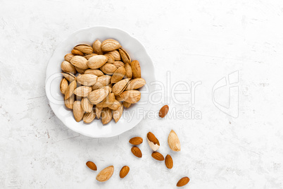 Almond nuts on white background directly above copy space flat lay