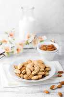 Almond nuts and milk on white background