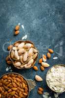 Almond nuts on dark background directly above copy space flat lay