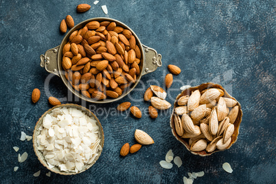 Almond nuts on dark background directly above copy space flat lay