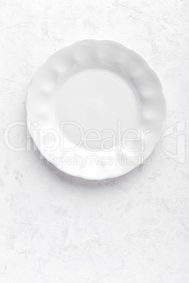 Empty white plate on white background top view copy space