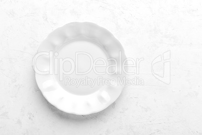 Empty white plate on white background top view copy space