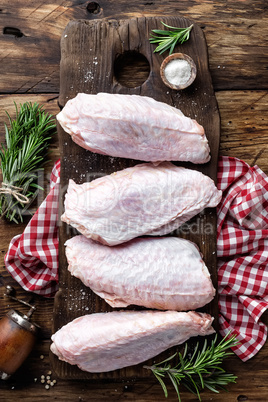 Raw turkey wings on wooden background top view, flat lay