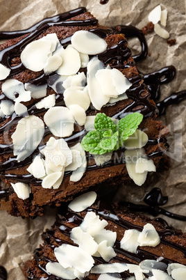 Chocolate brownie cake, dessert with nuts on dark background, directly above, flat lay