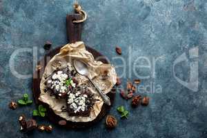 Chocolate brownie cake, dessert with nuts on dark background, directly above, copy space, flat lay