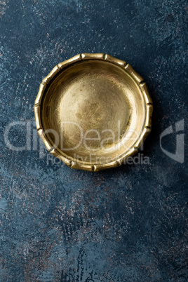 Empty metal plate on dark texture background top view, copy space