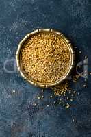 Fenugreek seeds on metal plate, spice, culinary ingredient