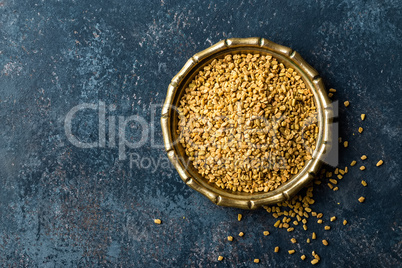 Fenugreek seeds on metal plate, spice, culinary ingredient