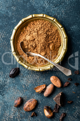Cocoa powder, beans and dark chocolate pieces crushed, culinary background, top view