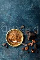 Cocoa powder, beans and dark chocolate pieces crushed, culinary background, top view