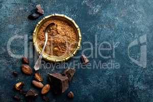 Cocoa powder, beans and dark chocolate pieces crushed, culinary background, top view