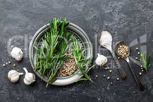 Rosemary, garlic, salt and white pepper, culinary background with various spices, directly above, flat lay, copy space