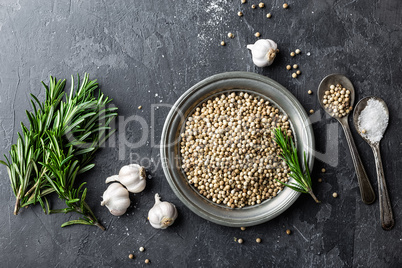 Rosemary, garlic, salt and white pepper, culinary background with various spices, directly above, flat lay, copy space