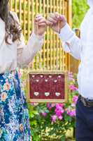 Couple holding wooden frame in hands