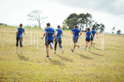 Fit people running in boot camp