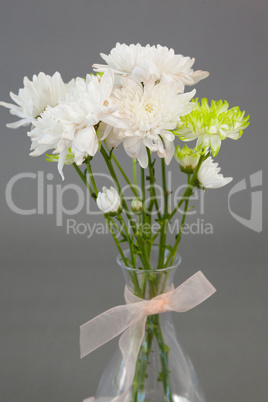 Close-up of flower vase tied with ribbon