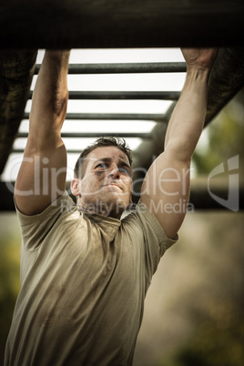 Soldier climbing monkey bars