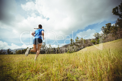 Fit woman running in bootcamp