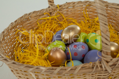 Various Easter eggs in wicker basket